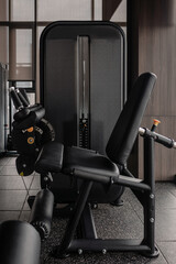 Obraz premium Leg extension machine in modern gym, strength training equipment close-up