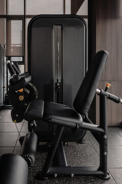 Leg extension machine in modern gym, strength training equipment close-up