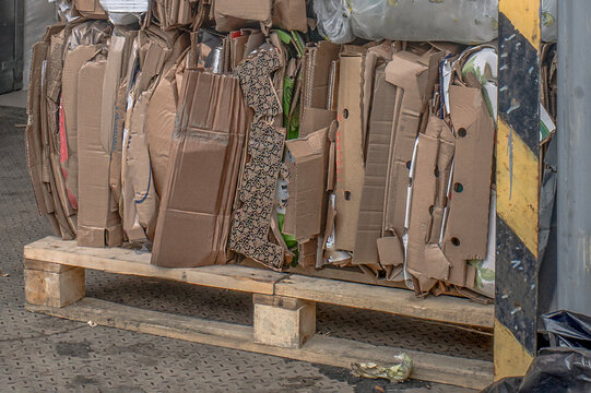 Used cardboard containers are stored on a pallet on a spring day