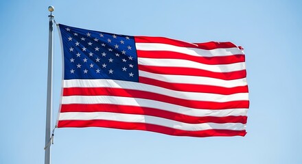 Obraz premium The American flag waving in the wind on a clear blue sky day