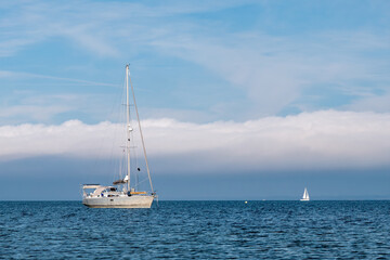 Fototapeta premium Sailboat at anchor in Kattegat off west coast of Æbelø island, north of Funen, Denmark