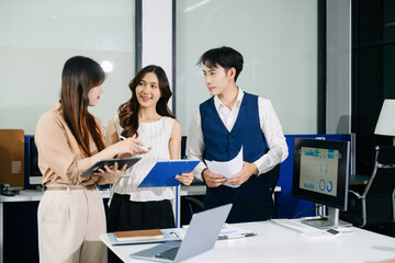 Fototapeta premium Group of Young Asian business team creative businesspeople coworker, teamwork celebrating achievement and in planning design in office