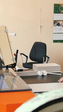 Worker works at polygraph machine, printing industry