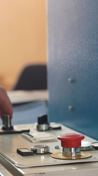 Red button on folding machine - printing polygraph industry, close up