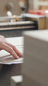 Worker works at polygraph machine, printing industry