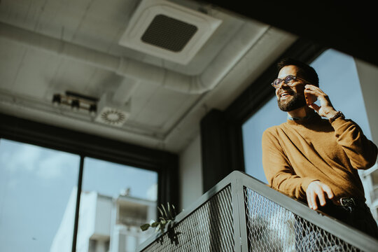Smiling man enjoys conversation in a bright modern office space