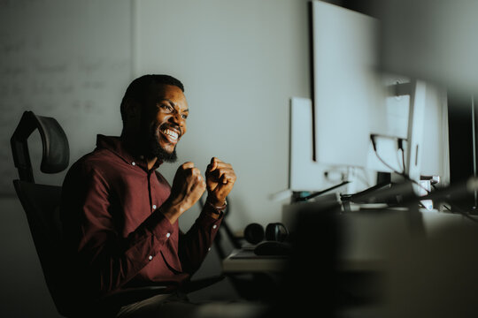 Celebrating success in a modern office setting during late evening hours
