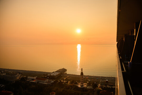 Golden sunset over the Black Sea from Orbi City balcony in Batumi Georgia, Luxury apartment view of the beach and coastline, Summer vacation and real estate investment concept, Romantic evening