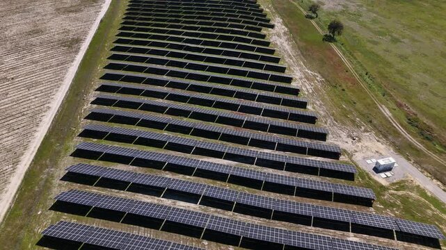 Aerial view of rows of solar panels in a large photovoltaic power station in a rural field in Palmela, Setubal, Portugal.