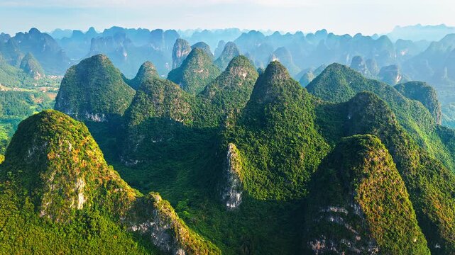 Aerial shot of spectacular karst mountain peak and green forest natural landscape in Guilin, China. 