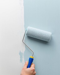 Obraz premium Step by Step Home Makeover Photography Showing a Person Rolling a Soft Blue Paint Tone Across an Interior House Wall 