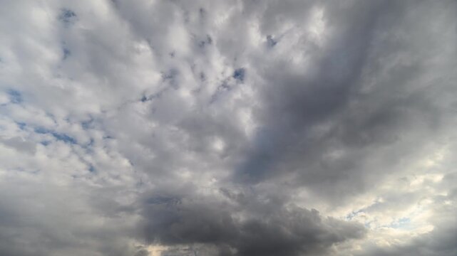 Clouds swirl rapidly. Sky darkens before storm arrival. Rapid cloud formations signal approaching tempest. Dramatic weather scene with swirling clouds and light rays