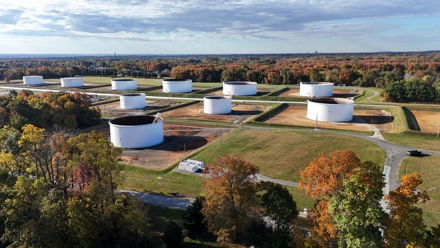 Aerial view of industrial storage tanks surrounded by autumn forest near Philadelphia Pennsylvania