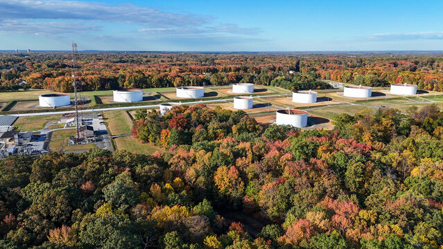 Aerial view of industrial storage tanks surrounded by autumn forest near Philadelphia Pennsylvania