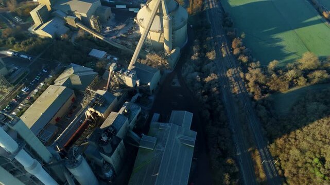 Low flying drone shot approaching the large scale industrial complex of Cemex in Rugby England.
