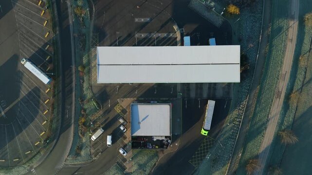 Top down aerial view of a busy petrol station forecourt with vehicles refueling in Rugby UK.