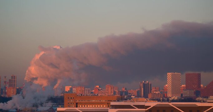 tuapse Huge industrial steam plume rolling above modern city buildings in soft golden sunrise light Dramatic urban skyline with dense atmospheric haze district heating infrastructure and environmental