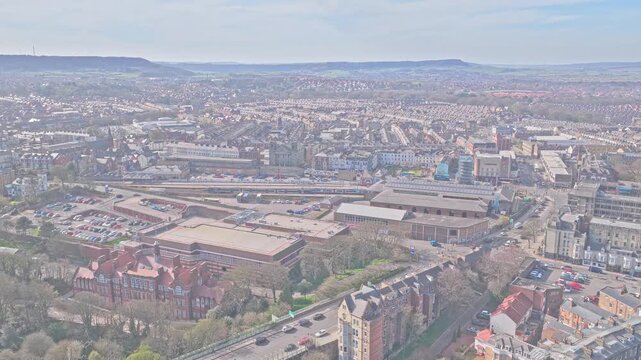 Scarborough Railway Station Westborough Scarborough North Yorkshire Yorkshire and the Humber England United Kingdom with York line terminus platforms and St Thomas Church, aerial static drone shot