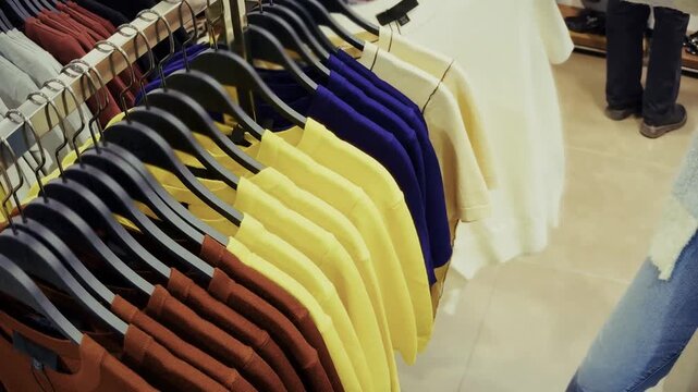 Shopper Browsing Clothing On Hangers In  Store. Shopping In Apparel Shop