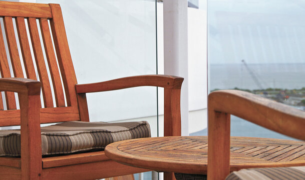 Deck chairs or sun loungers with table on balcony terrace patio promenade boat pool sun deck of luxury cruise ship cruiseship yacht liner with amazing oceanview