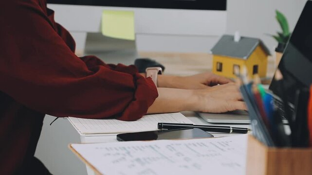 Business woman accountant working in office checking financial accounts and allocating company budgets.
