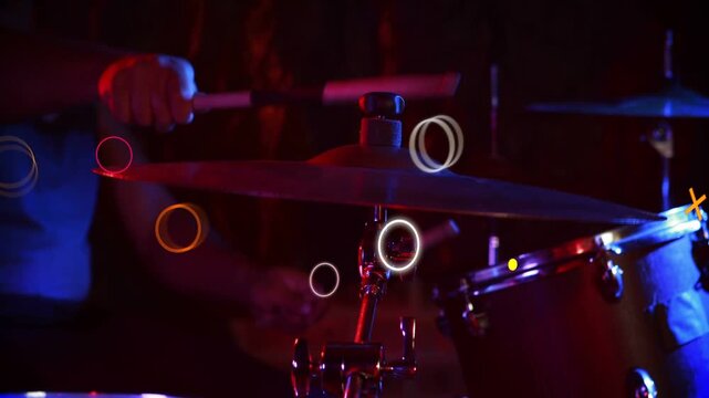 Vertical video: Male drummer striking snare and cymbal, first beat spawning neon shapes for music