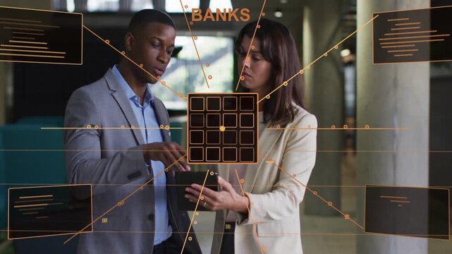 Man tapping tablet causing orange HUD morphing into 5x5 grid, colleagues analyzing BANKS and MEMORY