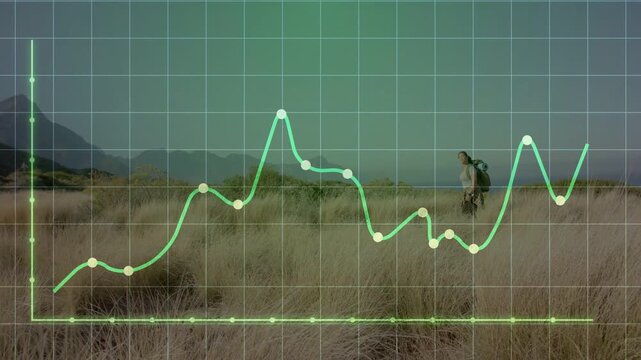 Vertical video: Hiker walking dunes as green graph tracing left axis overlaying her, showing data