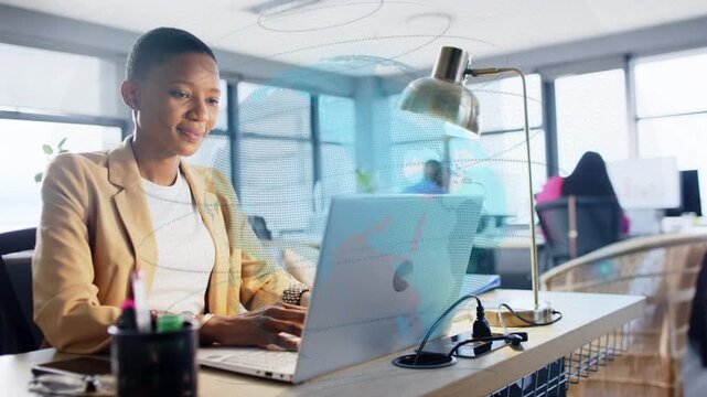Female office worker typing on laptop and generating blue overlay over desk and screen for business