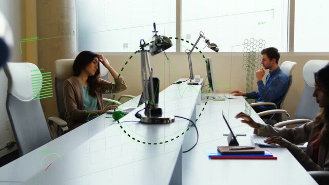 Team working at table, system starting green HUD framing workstations and visualizing business