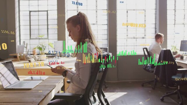 Woman sitting at desk scrolling phone checking markets causing finance charts tracking across frame
