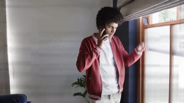 Man on phone moving toward window with scanline clearing adjusting blinds checking outside for tech