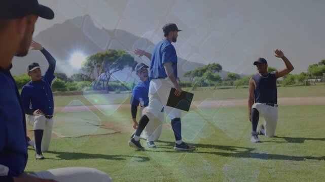 Coach walking on sports field with board, urging kneeling team raising arms, lens flare moving