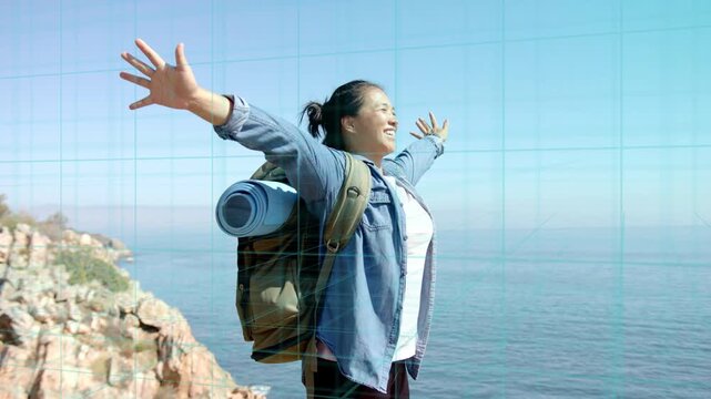 Woman hiker reaching cliff, raising arms into open pose facing ocean, backpack, grid showing health