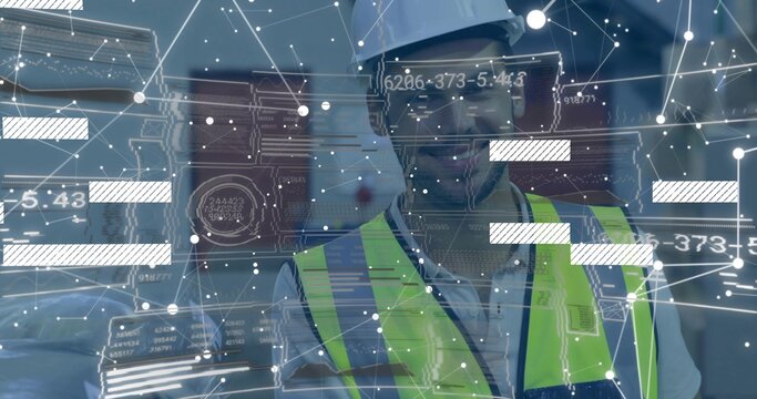 Standing site worker viewing AR data inside site corridor, wearing white hardhat and hivis vest