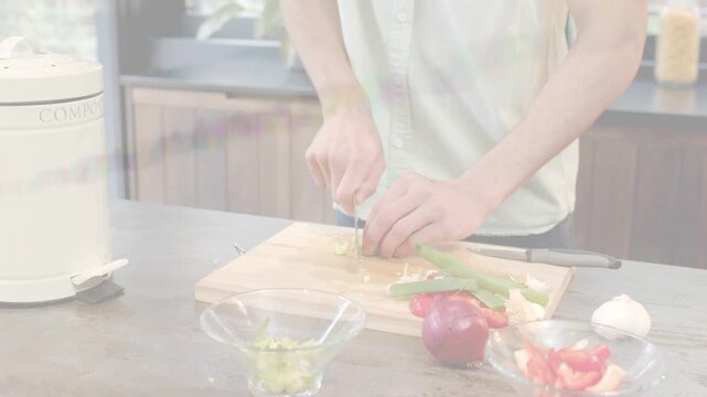 Home cook placing green stalk, chopping with chef knife on board, filling glass bowl for cooking