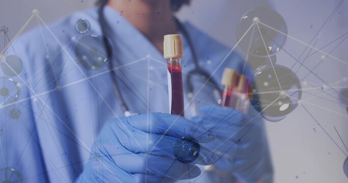 Holding gloved nurse in blue scrubs showing blood tubes with stethoscope, molecular overlay in lab