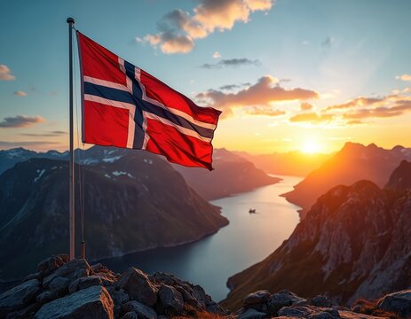 Norwegian flag waves on mountain peak at sunset. Fjord landscape below has calm water, distant ship. Golden sun sets behind rocky peaks, illuminating sky.