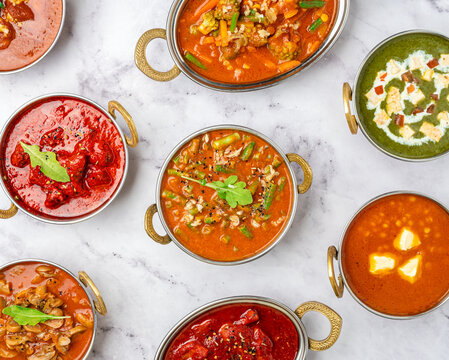 Chicken curry, beef handi, baigan korma, jalfrezi, butter dal, mutton masala. Set of colorful traditional Indian (Bangladesh, Pakistan, Asian) food on white table top view.  