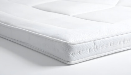 Fototapeta premium Close-up of a clean white mattress with stitched edges on a white background.