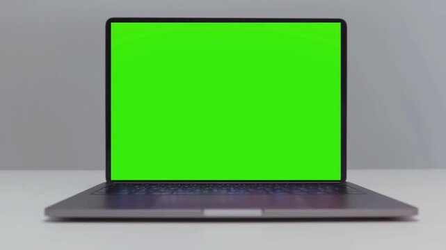 Modern Laptop with Green Screen on White Background for Mockup and Editing