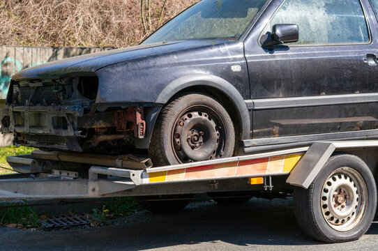 Old broken car for restoration on a trailer