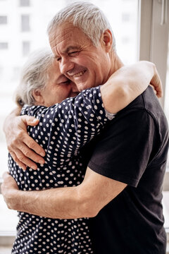 Senior couple joyfully sharing tender embrace