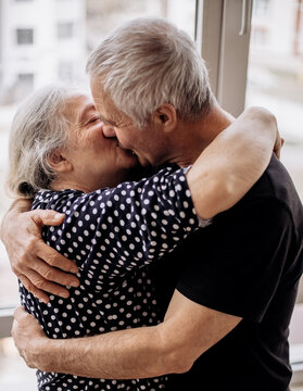 Senior couple sharing tender kiss and embrace