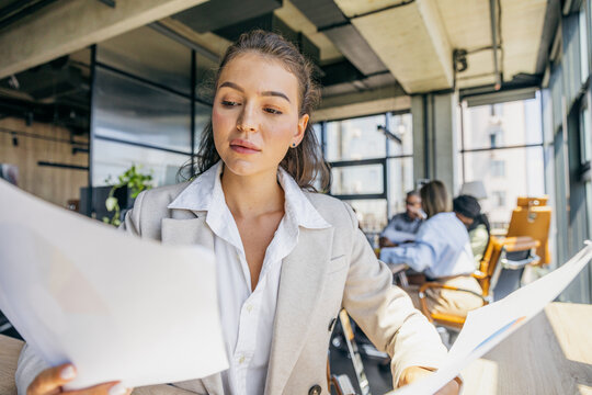 Legal specialist carefully studies contractual notes in workspace