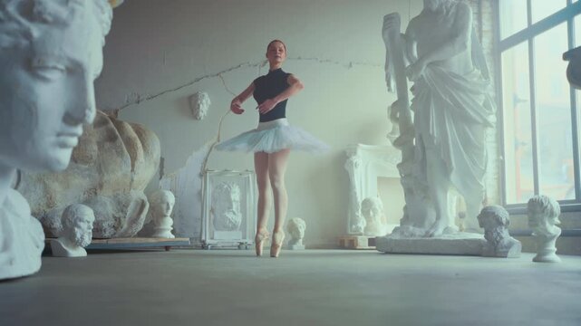 Slender ballerina in white tutu and pointe shoes dancing alone in rehearsal room, vertical portrait. Female ballet dancer performing classical choreography, talent and self-expression, slow motion