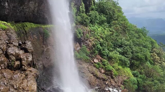 Laxmi Waterfall at Madhe Ghat flows down towering cliffs in stunning 4K, surrounded by misty valleys and lush greenery, capturing the wild beauty of Sahyadri monsoon magic.