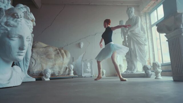 Carefree emotional ballerina dancing in rehearsal hall, jumping and flying. Beautiful young woman in white tutu and pointe shoes performing amazing classical choreography, slow motion, female grace