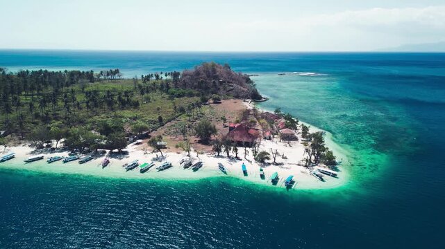 Aerial drone view Gili Sudak Indonesia sunny day featuring white sand beach turquoise lagoon tropical paradise island landscape