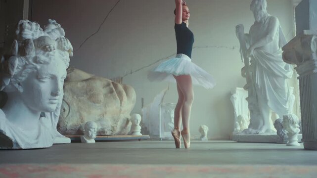 Ballerina dancing in museum, contemporary art performance, slow motion shot. Female grace and beauty, beautiful woman expressing herself by dance, enjoy classical music, dance, sculpture and history